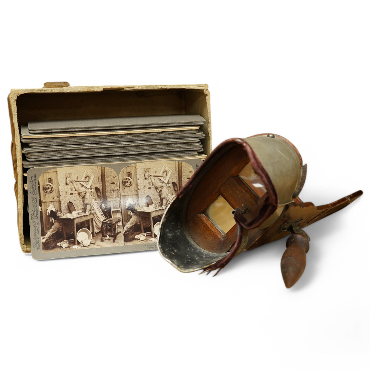 A stereoscope viewer with a collection of comical viewing cards. Condition - cards - fair/good, viewer - poor